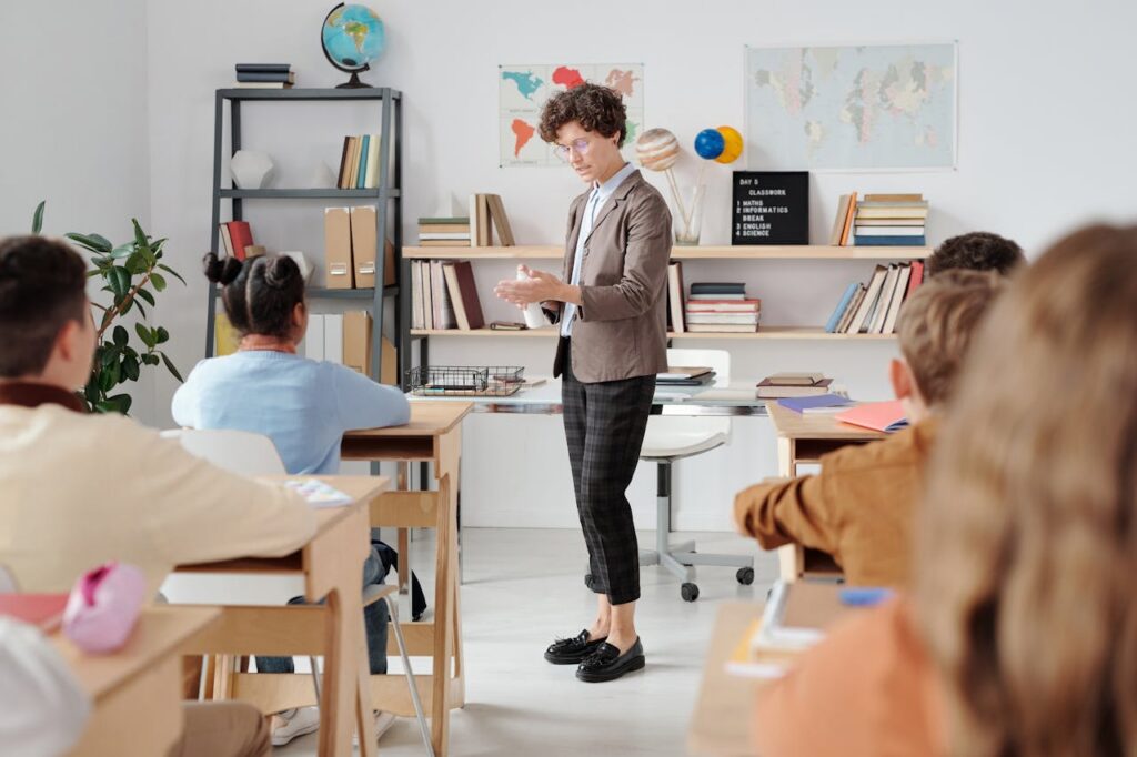 Teacher conducting a classroom lesson with attentive students in a vibrant educational setting.